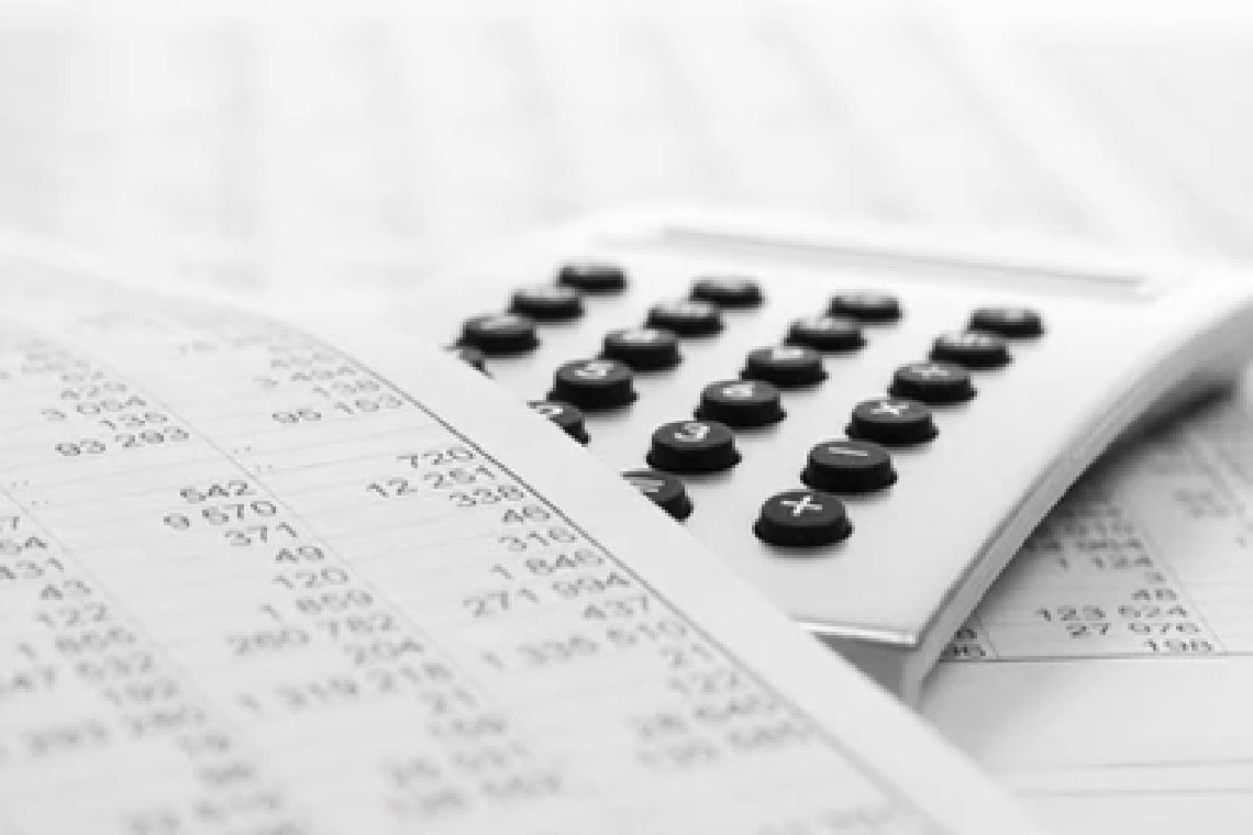 Black and white calculator and bills
