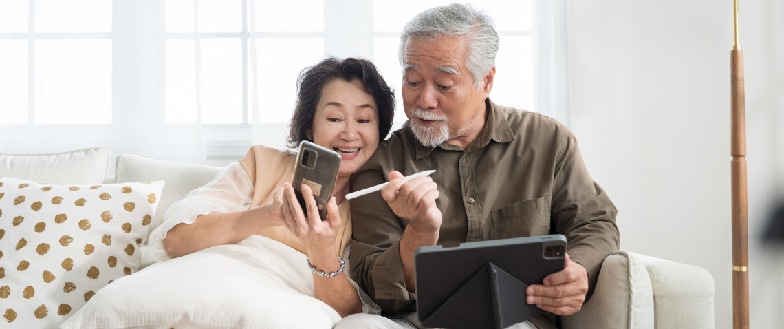 senior couple looking at devices