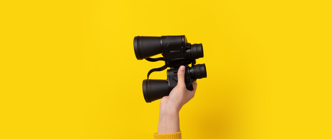 yellow background with binoculars